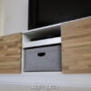 Custom-made bin in light grey in a tv-board shelf