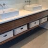 Custom-made bins in oatmeal set in vanity storage