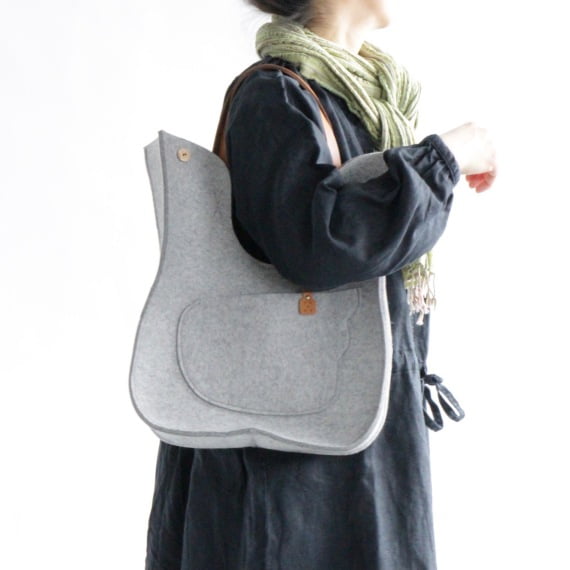 Bird handbag in light grey, with a model